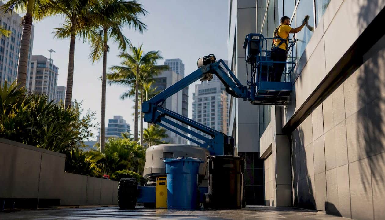 Crew using mechanical lift for high exterior cleaning