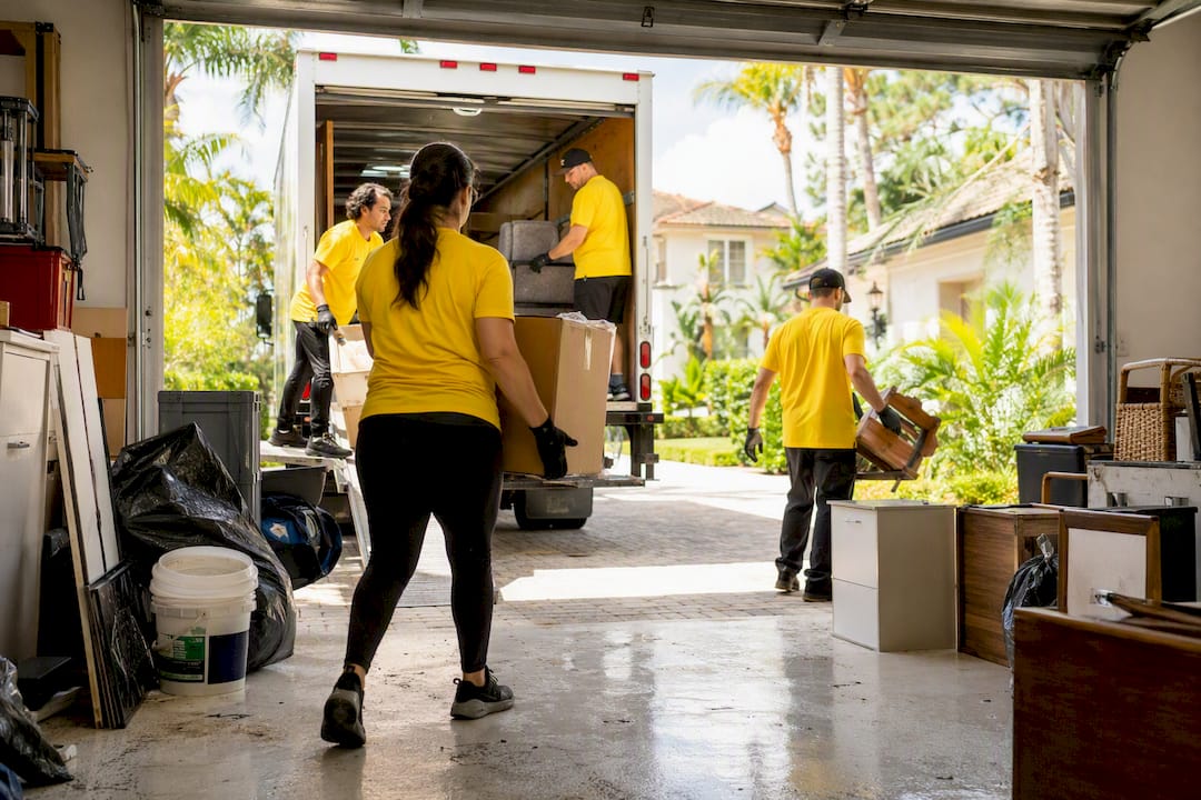 Cleaning crew clearing garage junk in Tampa