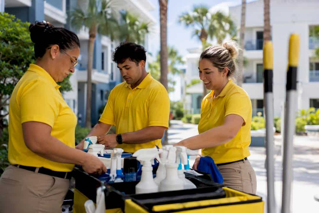 Cleaning crew preparing supplies outside apartment