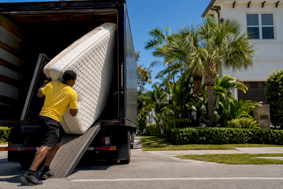 Floridacc crew loading mattress into truck