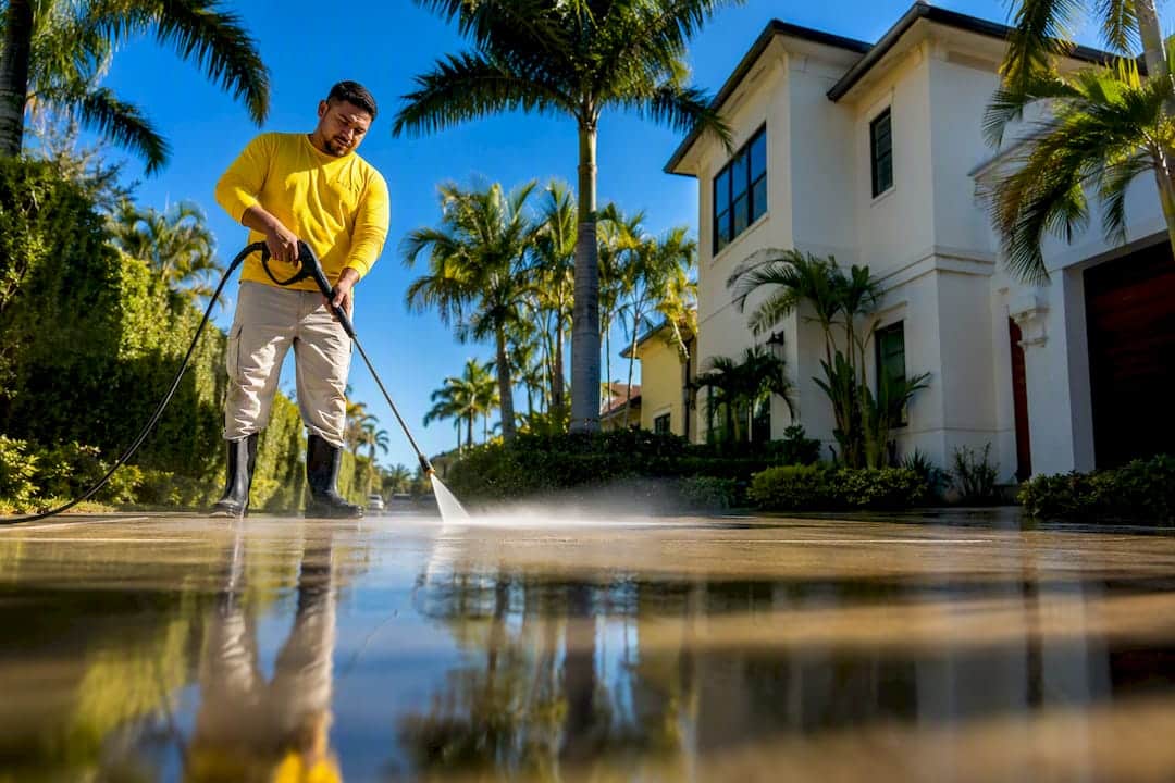 Crew pressure washing Tampa Bay driveway